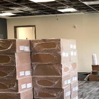 A stack of boxes in a room under construction.